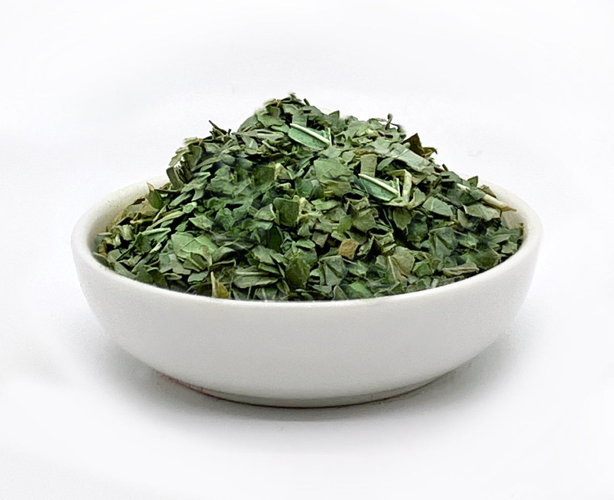 Basil freeze-dried herbs in a bowl — side view